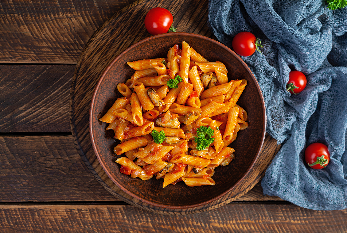 Penne pasta with tomato sauce and garnish
